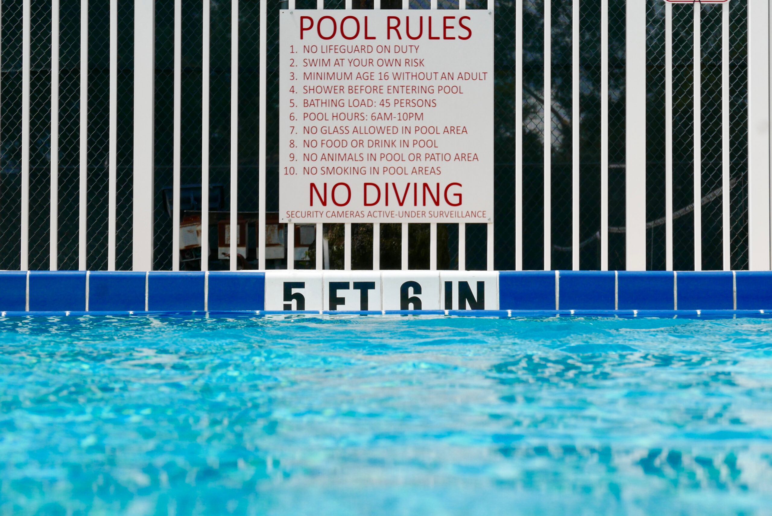 Pool rules sign at the deep end of a swimming pool