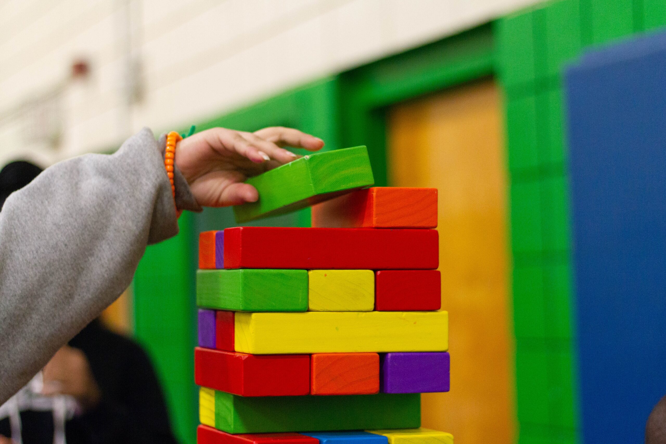 child stacking building blocks