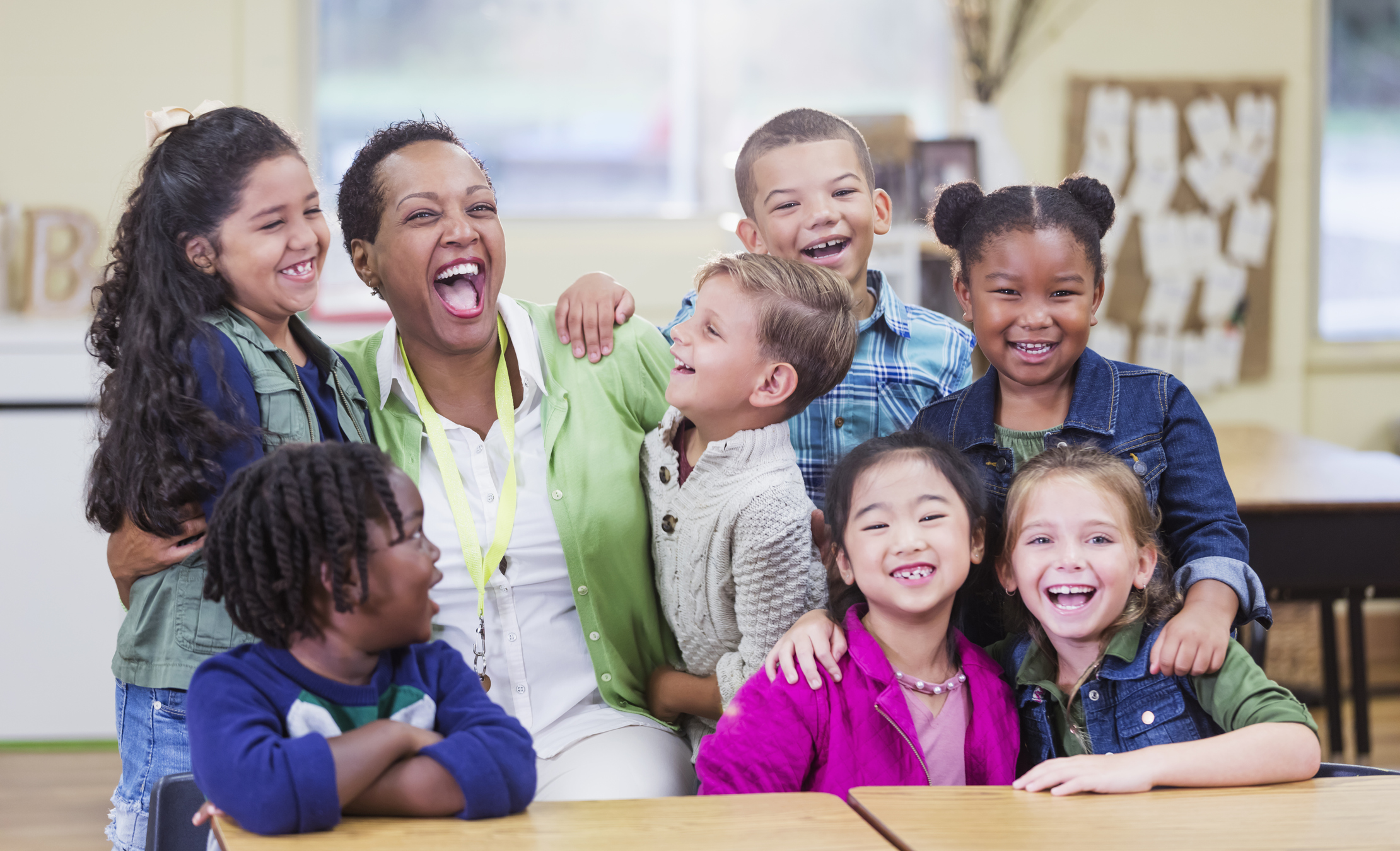 teacher with elementary students laughing